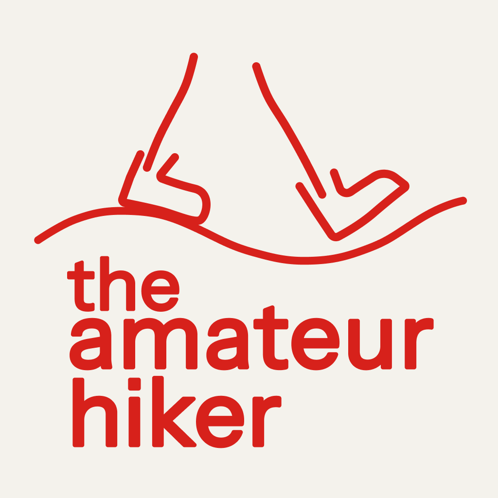 The amateur hiker logo: Two legs with boots walking on a wavy path, as drawn by an amateur drawer